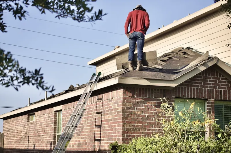 Professional roofer working on a residential roof in Gunston Heights
